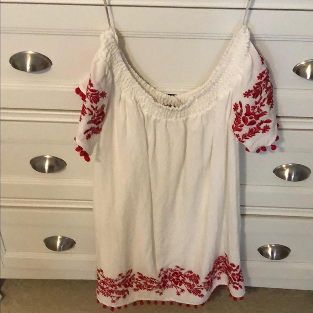 Off-the-shoulder white dress with red embroidery